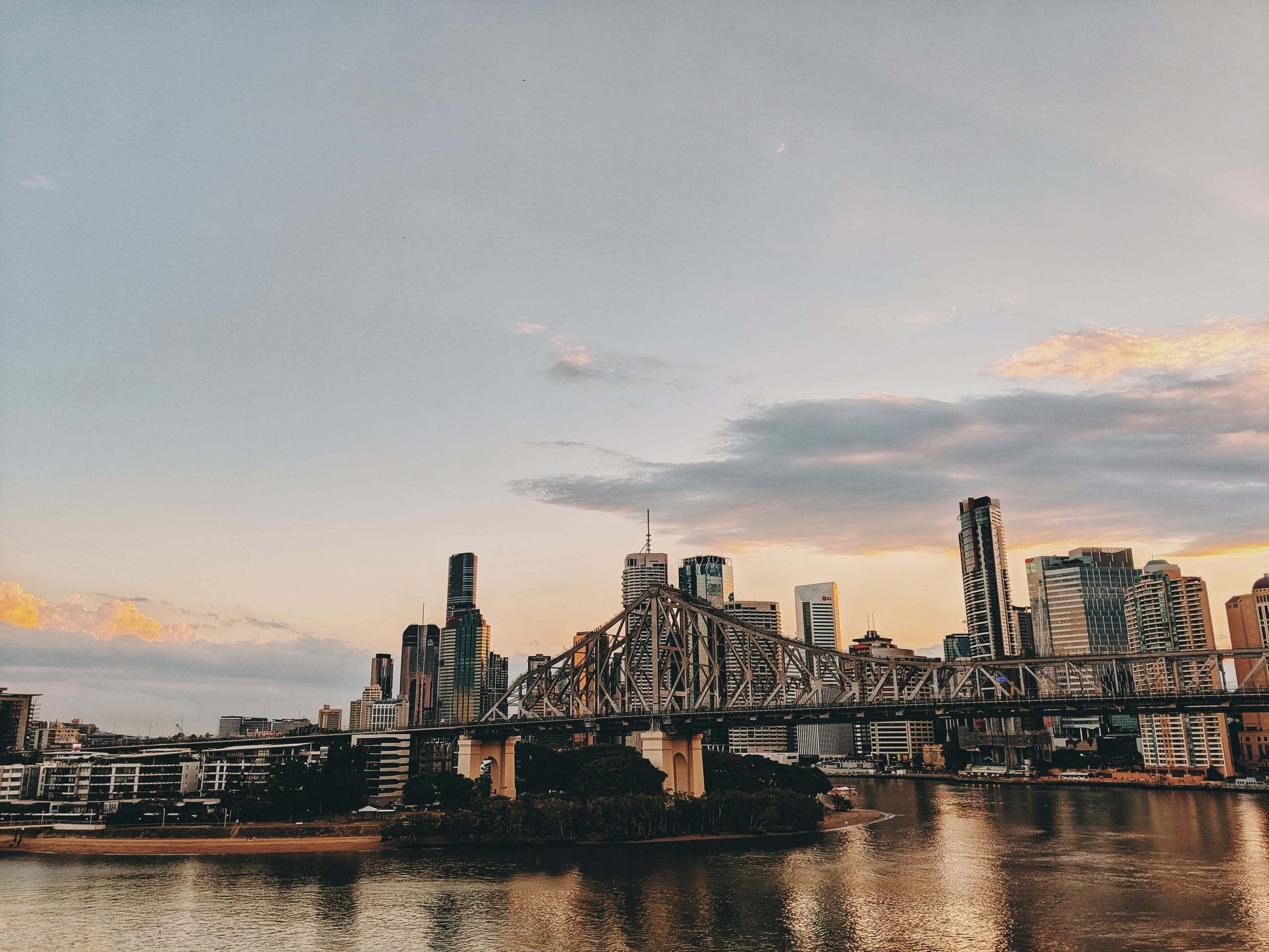 The Story Bridge and Brisbane's skyline at dusk, seen across the river