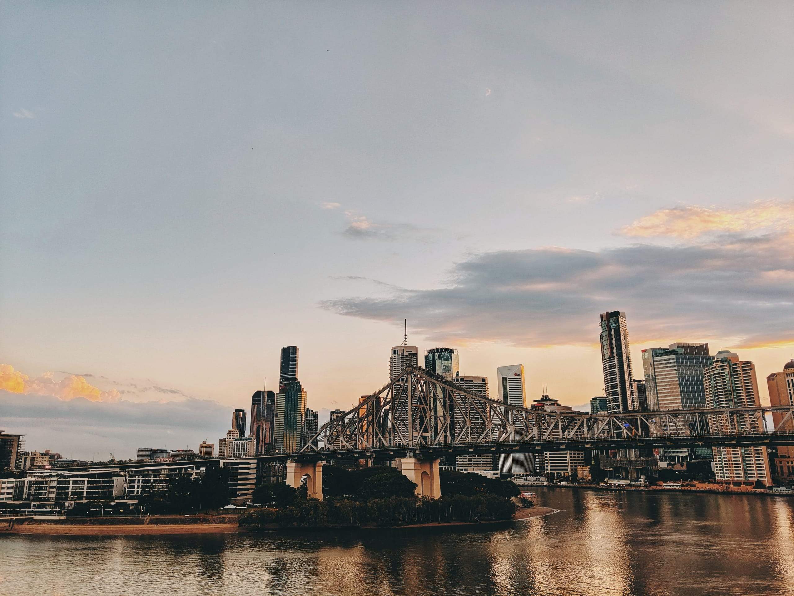 The Story Bridge and Brisbane's skyline at dusk, seen across the river